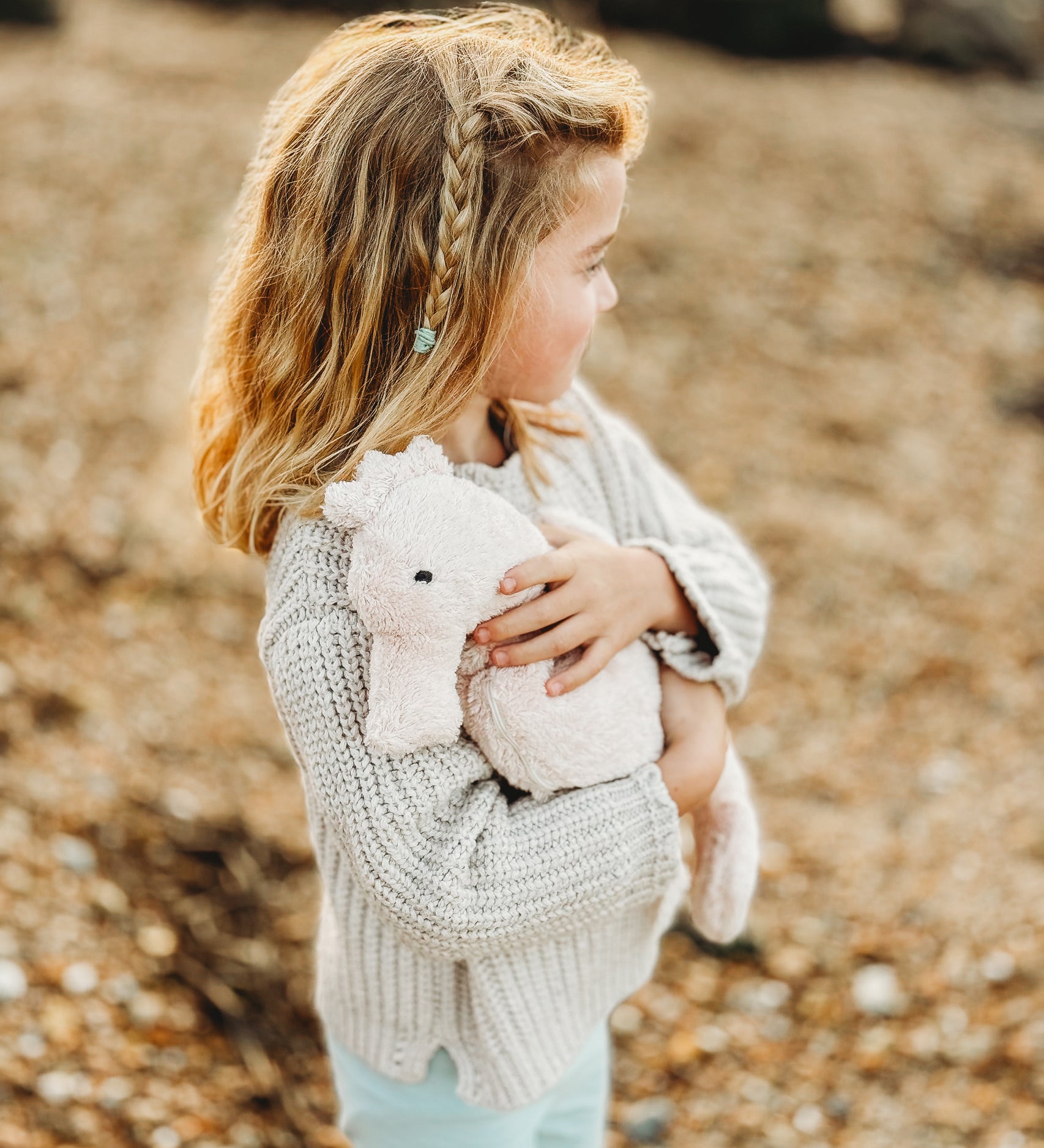 A child cudling the Senger Large Cuddly Seahorse soft toy.