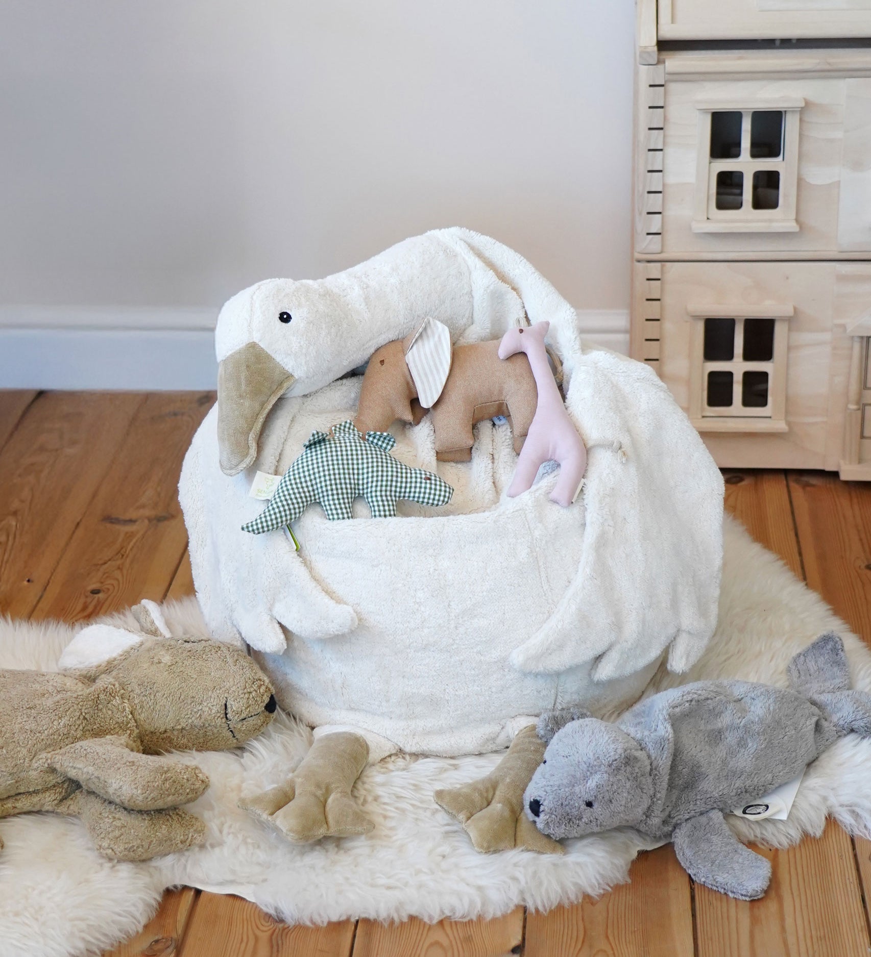 A Senger Goose bean bag shown with smaller Senger animals placed on it.