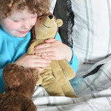 A child cuddling the Senger small floppy hedgehog, the child has both his hands wrapped around the organic soft toy. The hedgehog is part of a wider selection of soft toys made with organic cotton and natural fillings that are available at Babipur.
