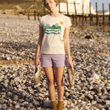 A woman wearing the Silverstick Habitats Organic T-Shirt in the Angora colourway.