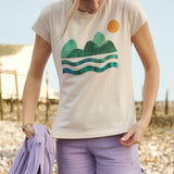 A woman wearing the Silverstick Habitats Organic T-Shirt in the Angora colourway.