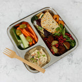 A Slice Of Green Stainless Steel Divided Plate. The plate has hummus in the smallest section, carrot, cucumber and olives in the middle section and flatbread, salad and falafels in the biggest section. This stainless steel plate is suitable for snacks and meals and perfect for children and adults.