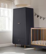 A slate SnuzKot Wardrobe pictured in a nursery placed next to a matching Snuzkot cot bed