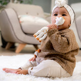 A child sat on a fluffy blanket