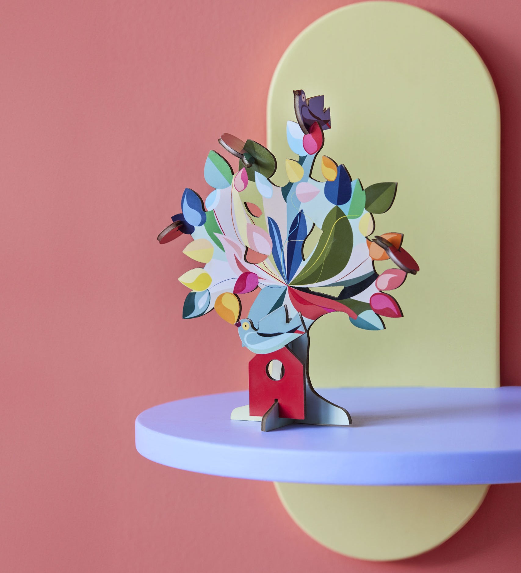 The Studio Roof 3D Pop Out Card Dream Tree on a purple shelf. A 3D cardboard DIY craft kit tree with different coloured leaves. This kit is part of a wide range of Studio Roof kits that are available at Babipur.