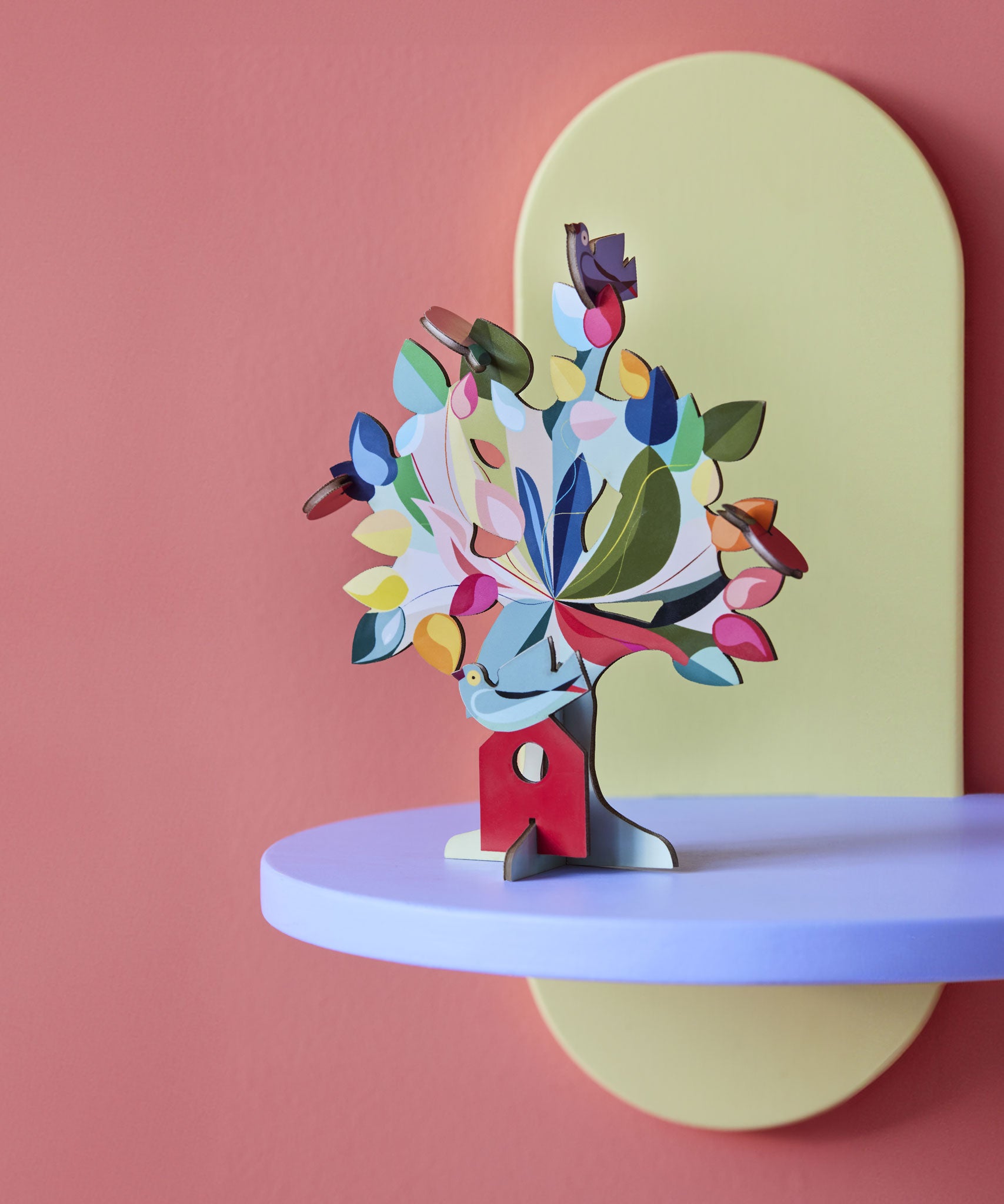 The Studio Roof 3D Pop Out Card Dream Tree on a purple shelf. A 3D cardboard DIY craft kit tree with different coloured leaves. This kit is part of a wide range of Studio Roof kits that are available at Babipur.
