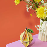 The Studio Roof 3D Pop Out Card Lemon placed on a sideboard next to flowers. This 3D pop out card DIY kit is part of Studio Roof's fruits  collection which is available at Babipur.