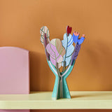 Studio Roof 3D Pop Out Card Tree of Life decoration placed on a shelf. A cardboard DIY craft kit that comes with a card. This kit is part of a wide range of Studio Roof kits that are available at Babipur.