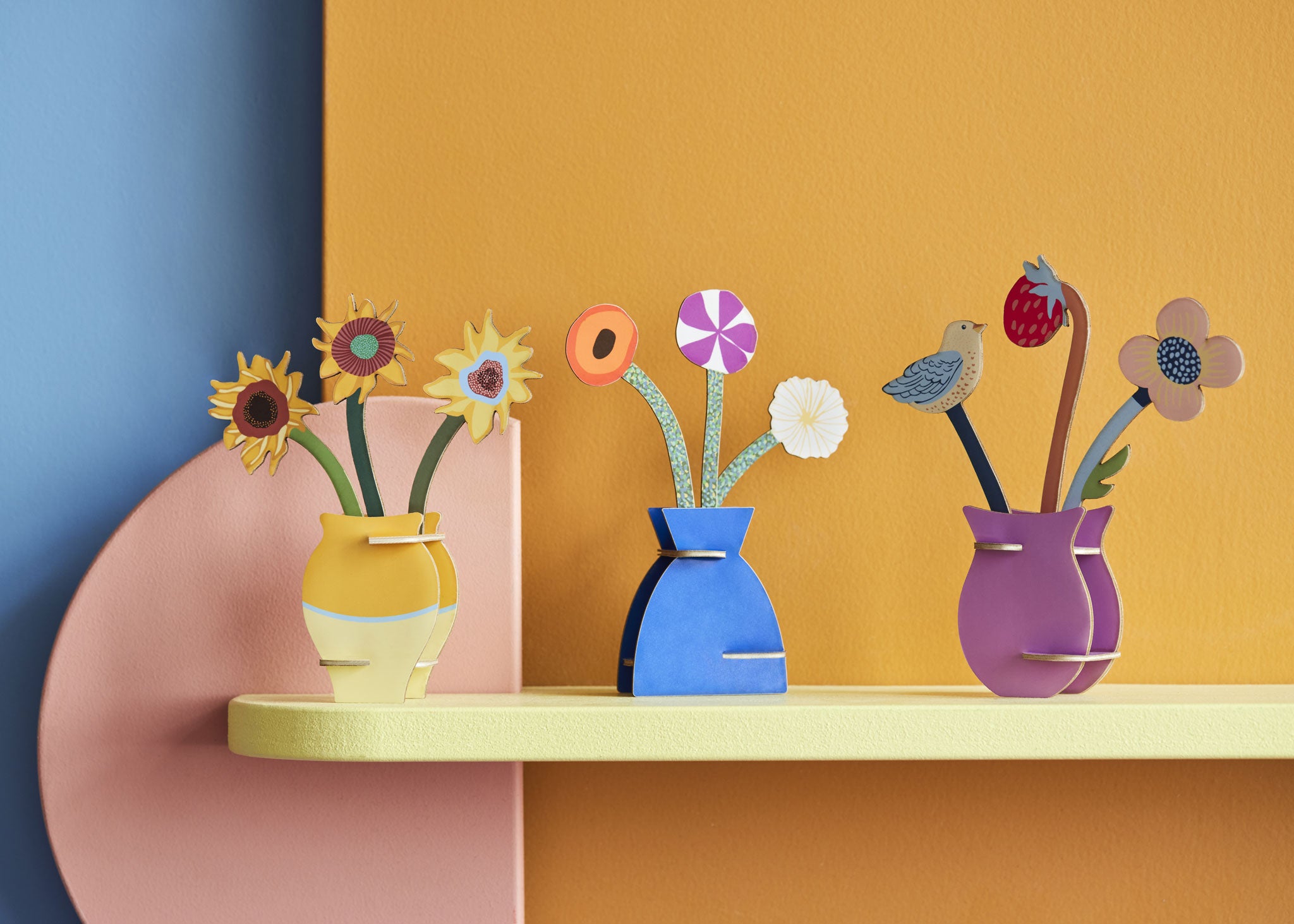 Three different Studio Roof 3D flowerr Pop Out Cards placed on a shelf. These 3D pop out card bouquet is part of Studio Roof's artist collection which is available at Babipur.
