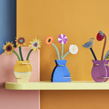 Three different Studio Roof 3D flowerr Pop Out Cards placed on a shelf. These 3D pop out card bouquet is part of Studio Roof's artist collection which is available at Babipur.