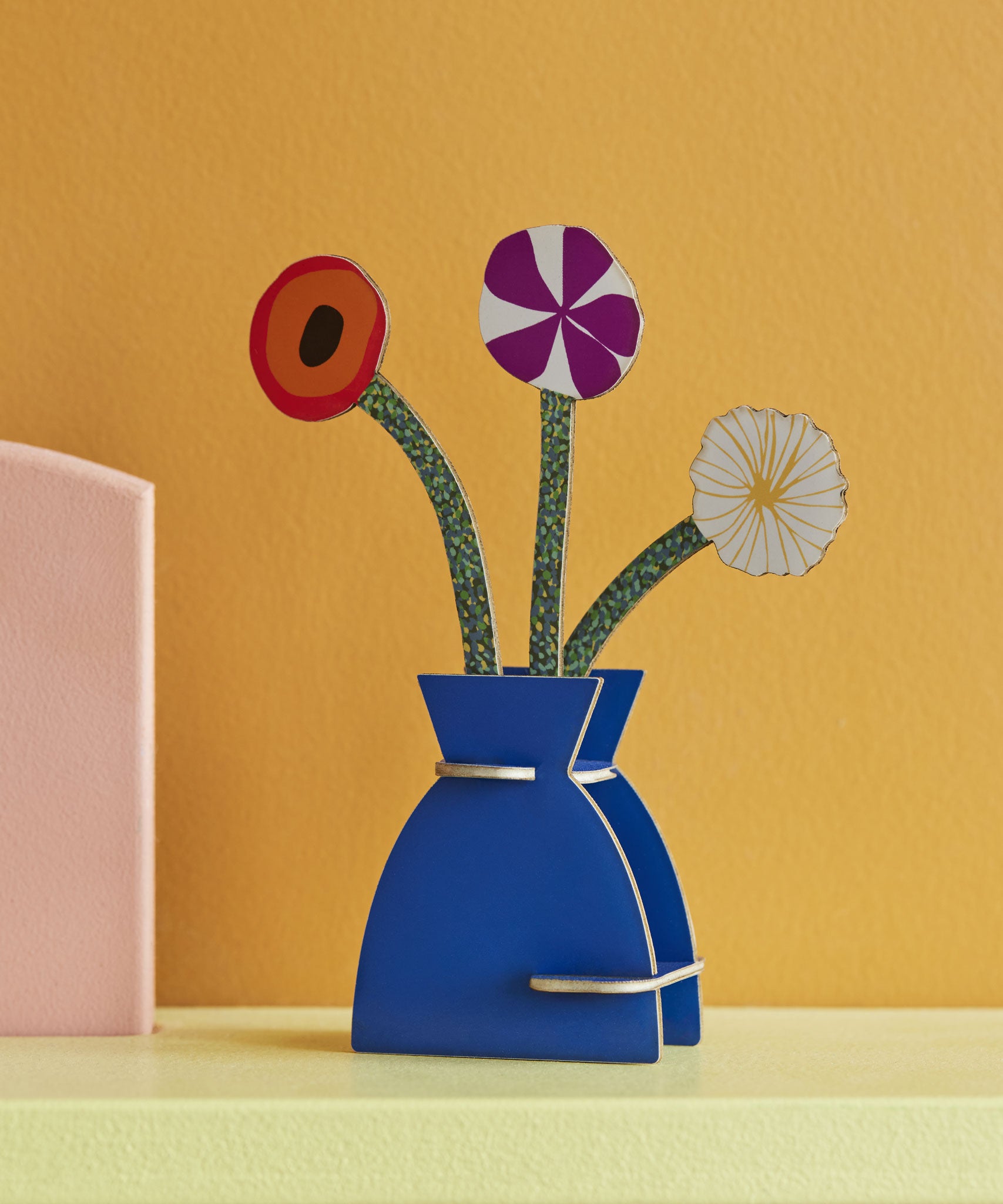 Studio Roof 3D Pop Out Card featuring a Klimt Flowers design placed on a shelf on front of a yellow wall. This 3D pop out card bouquet is part of Studio Roof's artist collection which is available at Babipur.