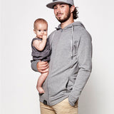 An adult wearing the Love Radius Parents Hoodie In Heather Grey. On a light grey background