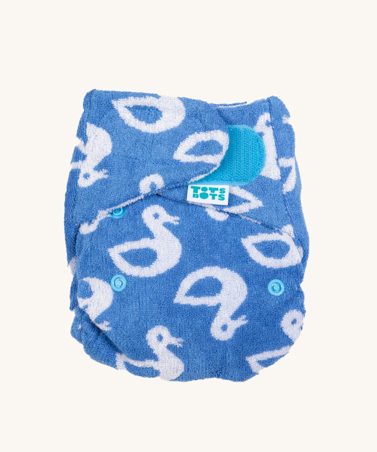 Tots Bots Bamboozle Stretch Bamboo Nappy in lucky duck is a blue highly absorbent fitted nappy. Features a  velcro fastener and a white duck print.