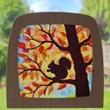 A Toverlux DIY Transparencies with  Autumn Squirrel artwork shown in a wooden magic window frame.