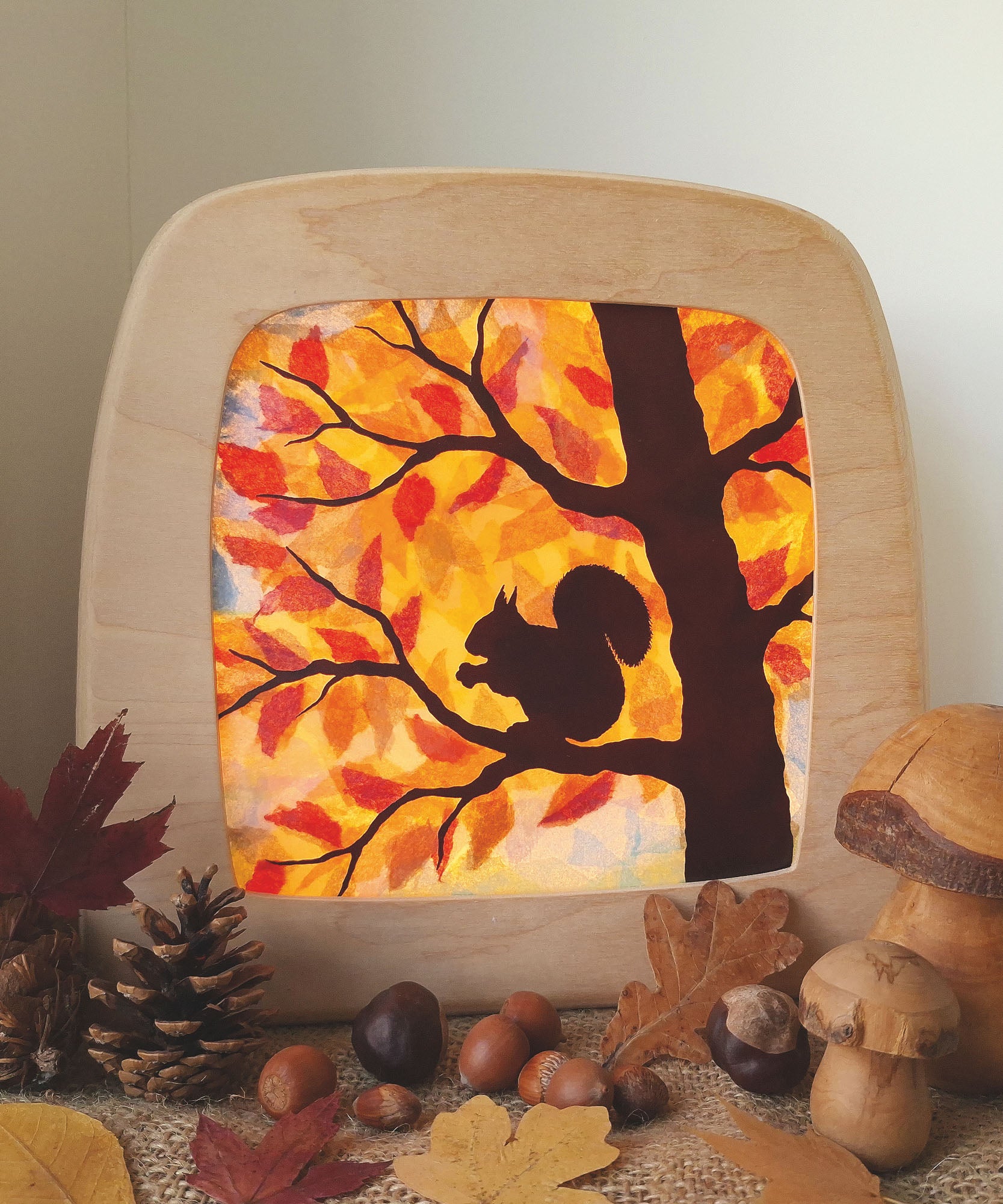 A Toverlux DIY Transparencies with  Autumn Squirrel artwork shown in a Toverlux wooden magic lamp.