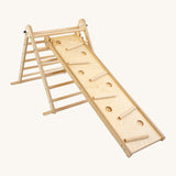 riclimb wooden pikler climbing frame with pastel themed rungs including purple blue, green, yellow, orange and pink. Showing the Triclimb Miri slide hooked on a rung and the sticks in matching pastel colours in the slots on the Miri slide