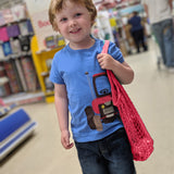 A child carrying the Turtle Bags kids size organic cotton string produce net bag