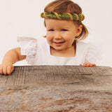 Child wearing the vah green Isabella Medieval Veil and a white dress
