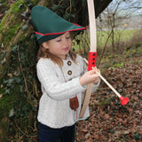 Child outdoors playing with the Vah Mini Wooden Bow with Safety Arrows
