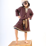 Child wearing a Vah Wiki Viking Helmet with Glasses stood on a wicker hamper