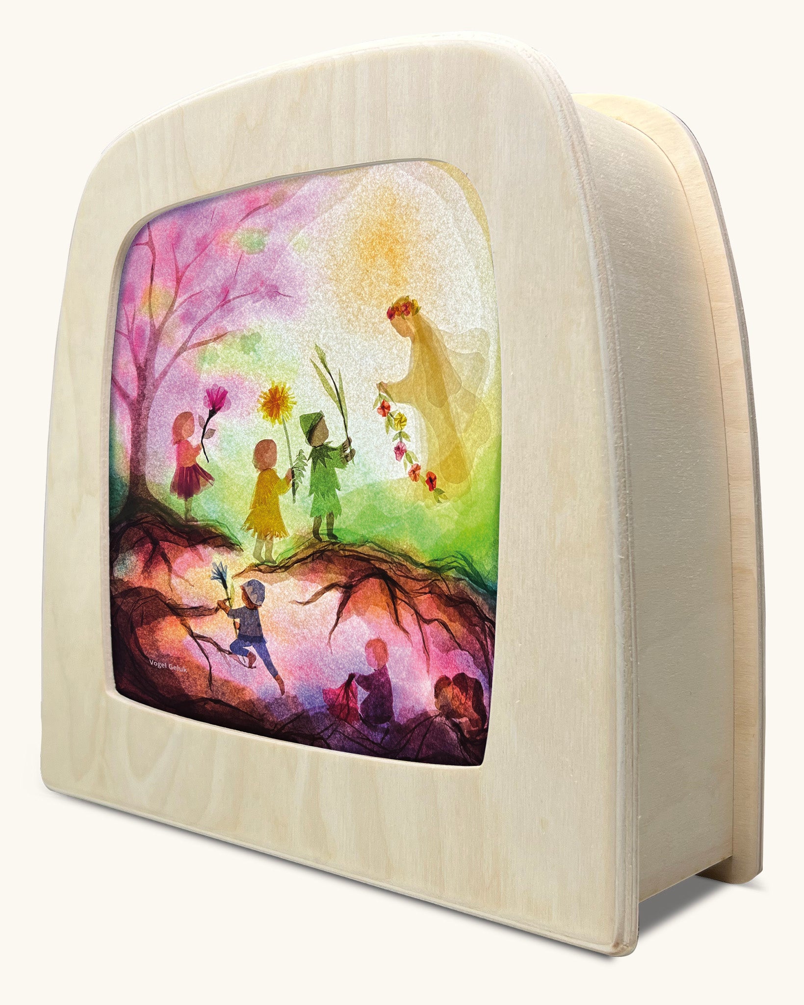 A Toverlux silhouette inside a wooden  lamp. This silhouette has children walking towards a fairy in the spring woods. This layered paper style silhouette is by artist Vogel Geluk and available at Babipur.
