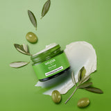 An open pot of Weleda Skin Food Nourishing Day Face Cream available at Babipur showing the texture of the cream
