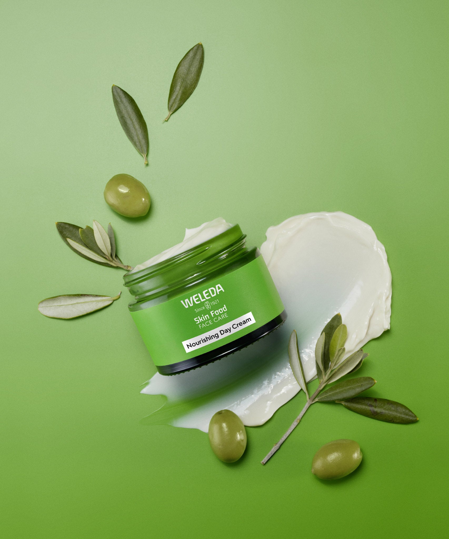 An open pot of Weleda Skin Food Nourishing Day Face Cream available at Babipur showing the texture of the cream