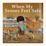 The front cover of When My Senses Feel Safe By Windy Brzezinska. A beautifully illustrated children's story book, with the cover showing a child in a playing with ball run pieces in a playroom