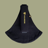 Wildride toddler carrier in black. A 100% cotton seat stylish hip carrier for babies with brand name in yellow on the strap that's folded over the carrier's seat