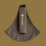 Wildride toddler carrier in coffee brown. A 100% cotton seat stylish hip carrier for babies with brand name on the strap that's folded over the carrier's seat