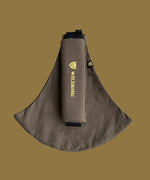 Wildride toddler carrier in coffee brown. A 100% cotton seat stylish hip carrier for babies with brand name on the strap that's folded over the carrier's seat