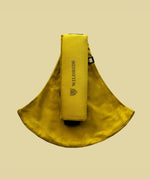 Wildride toddler carrier in desert yellow. A 100% cotton seat stylish hip carrier for babies with brand name on the strap that's folded over the carrier's seat