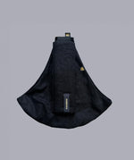 Wildride toddler carrier in black linen. A stylish hip carrier for babies with a black brand patch on the strap that's folded over the carrier's seat