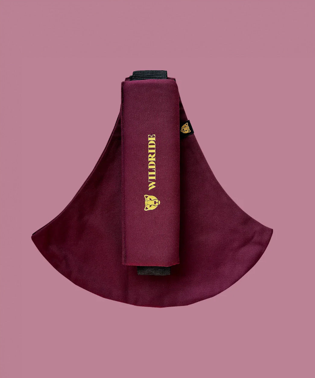 Wildride toddler carrier in merlot maroon. A 100% cotton seat stylish hip carrier for babies with brand name on the strap that's folded over the carrier's seat