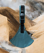 A side view of the ocean Wildride toddler carrier showing the buckle and seat detail. Features a brand patch on the buckle.