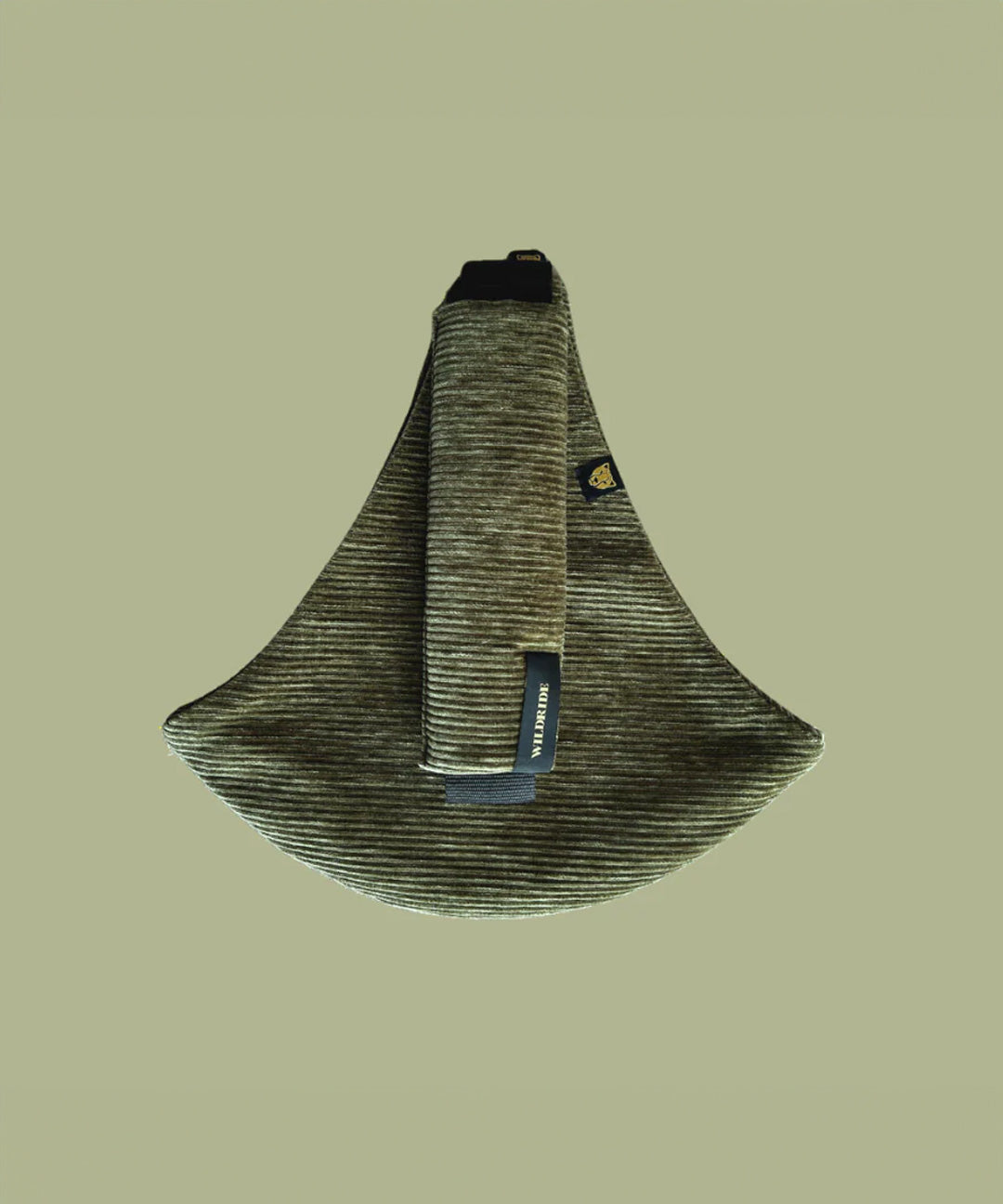 The oliive green Wildride corduroy toddler carrier, on a green background.