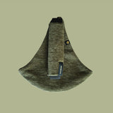 The oliive green Wildride corduroy toddler carrier, on a green background.