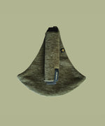 The oliive green Wildride corduroy toddler carrier, on a green background.