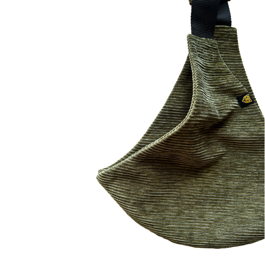 A closeup of the soft corduroy material that the olive Wildride corduroy carrier is made from.