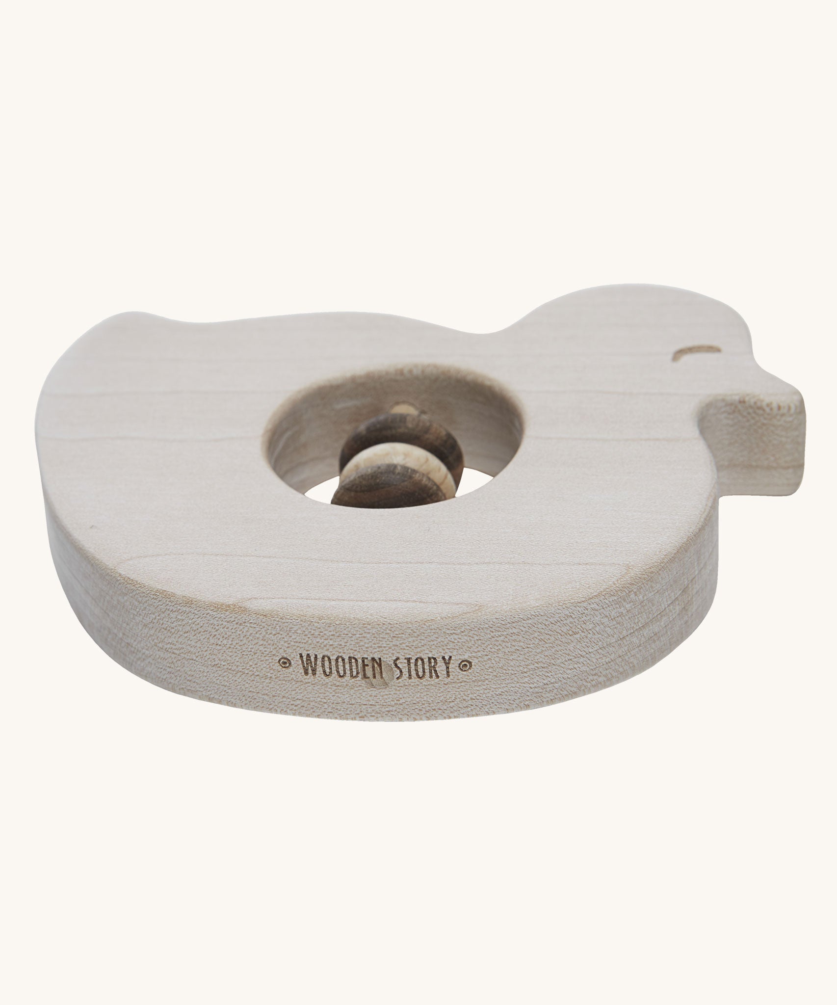 Wooden Story Baby Duck Rattle on a plain background. The rattle has been pictured from the side the Wooden Story logo can be seen etched onto the edge.