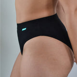 Close up of a woman wearing the WUKA tencel bikini brief underwear on a grey background