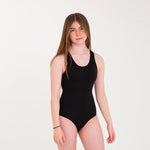 Young woman stood on a grey background wearing the WUKA eco-friendly period swimsuit