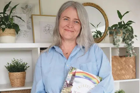 Zoe the founder of The Phive holding the storywriters book.