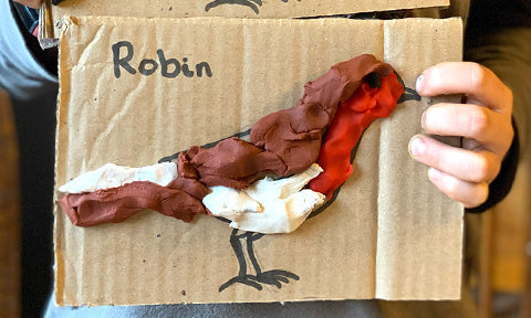 Child’s robin bird made from OkoNorm playdough on recycled cardboard, simple bird craft for children inspired by the Big Garden Birdwatch