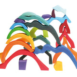Pieces from the Grimm's Small 4 Elements Building Set stacked up on top of each other. 