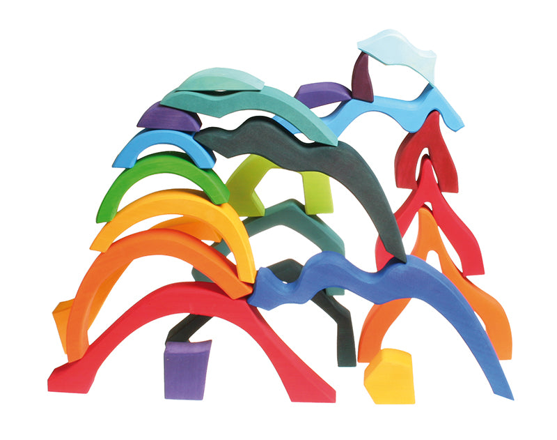 Pieces from the Grimm's Small 4 Elements Building Set stacked up on top of each other. 