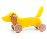 Bajo handmade yellow wooden dachshund puppy toy on a white background