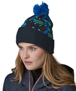 A female adult wearing the blue Patagonia bobble beanie.