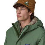 A male adult wearing the brown Patagonia beanie.