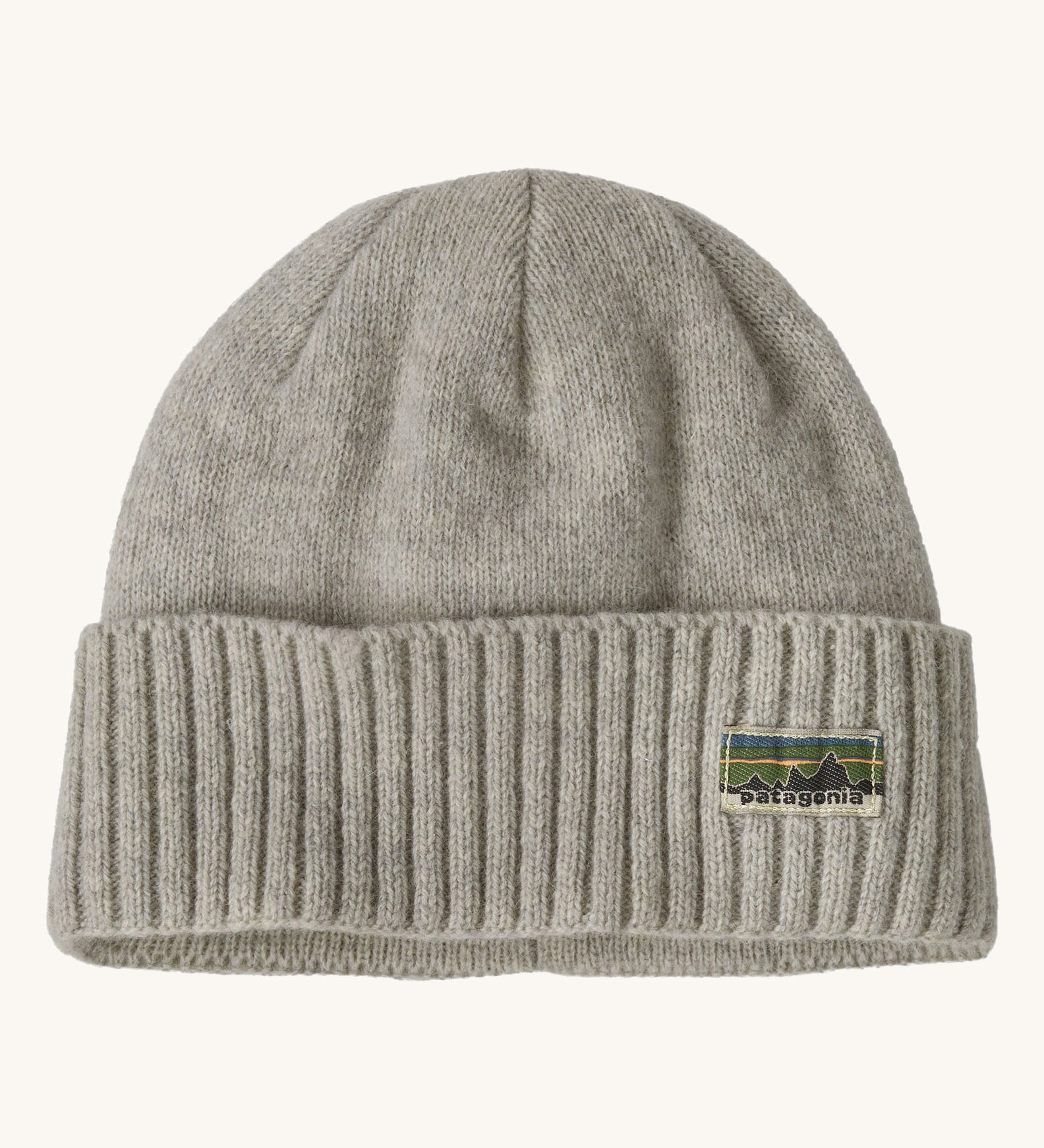 A grey beanie with the Patagonia logo on the front on a cream background